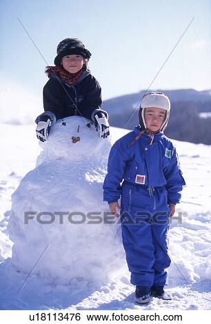 Stock Photograph - Two Children and Snowman. Fotosearch