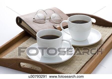 Two cups of coffee on a tray View Large Photo Image Stock Image - Two cups of coffee on a tray. Fotosearch