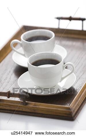 Two cups of coffee on a tray View Large Photo Image Stock Photo - Two cups of coffee on a tray. Fotosearch