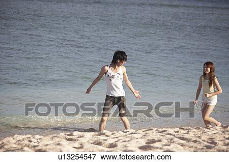 Young couple walking on beach, Guam, USA View Large Photo Image Stock Photo - Young couple walking on beach, Guam, USA. Fotosearch