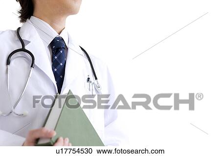 Stock Image - Young male doctor holding a book. Fotosearch