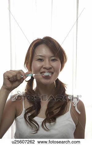 Young woman brushing her teeth View Large Photo Image Stock Image - Young woman brushing her teeth . Fotosearch