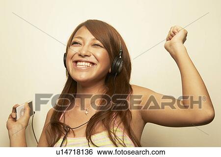 Young woman dancing to music View Large Photo Image Stock Photograph - Young woman dancing to music . Fotosearch