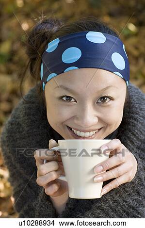 Picture - Young Woman Drinking Hot Drink. Fotosearch