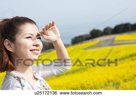 Young woman looking at sun View Large Photo Image Stock Photograph - Young woman looking at sun. Fotosearch