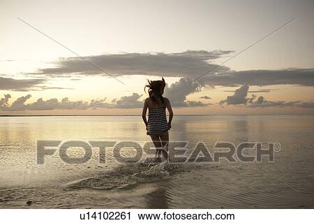 Young woman running into sea, Guam, USA View Large Photo Image Stock Image - Young woman running into sea, Guam, USA. Fotosearch