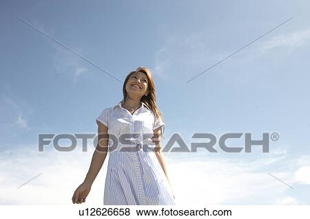 Young woman standing and looking up, Guam, USA View Large Photo Image Stock Photo - Young woman standing and looking up, Guam, USA. Fotosearch