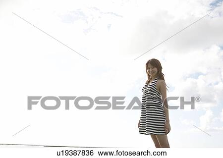 Stock Photograph - Young woman standing, Guam, USA. Fotosearch