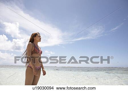 Young woman standing in water, Guam, USA View Large Photo Image Picture - Young woman standing in water, Guam, USA. Fotosearch