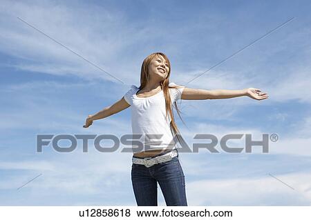 Stock Photo - Young woman stretching, Guam, USA. Fotosearch