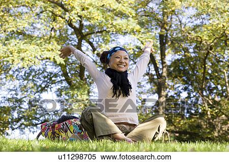 Stock Photography - Young Woman Stretching in Park. Fotosearch