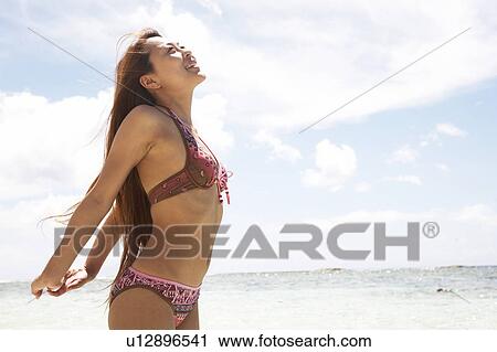 Young woman stretching in water, Guam, USA View Large Photo Image Stock Image - Young woman stretching in water, Guam, USA. Fotosearch