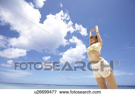 Young woman stretching in water, Guam, USA View Large Photo Image Stock Photo - Young woman stretching in water, Guam, USA. Fotosearch