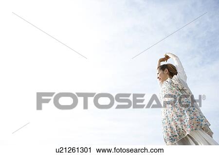Stock Image - Young woman stretching. Fotosearch
