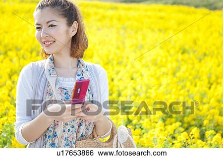 Young woman using cell phone View Large Photo Image Stock Photograph - Young woman using cell phone. Fotosearch