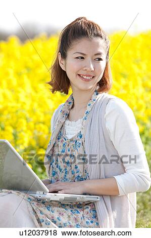 Young woman using laptop outdoors View Large Photo Image Stock Photo - Young woman using laptop outdoors. Fotosearch