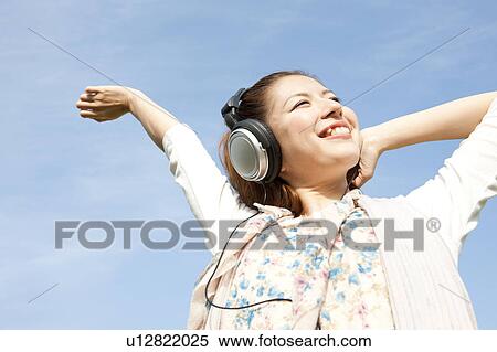 Young woman with headphones View Large Photo Image Stock Photography - Young woman with headphones. Fotosearch