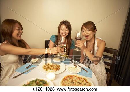 Young women eating dinner View Large Photo Image Stock Photograph - Young women eating dinner. Fotosearch