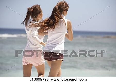Young women jogging on beach, Guam USA View Large Photo Image Stock Photo - Young women jogging on beach, Guam USA. Fotosearch