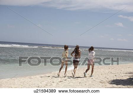 Young women jogging on beach, Guam USA View Large Photo Image Stock Photo - Young women jogging on beach, Guam USA. Fotosearch