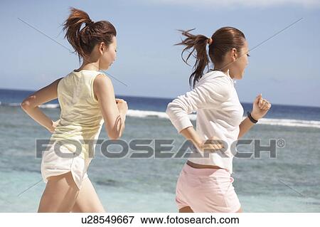Young women jogging on beach, Guam USA View Large Photo Image Stock Photo - Young women jogging on beach, Guam USA. Fotosearch