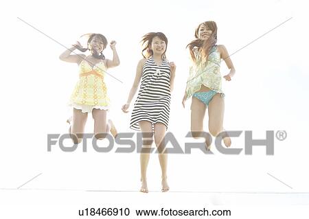 Young women jumping in mid-air, Guam, USA View Large Photo Image Stock Image - Young women jumping in mid-air, Guam, USA. Fotosearch