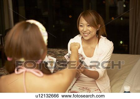 Young women playing cards View Large Photo Image Stock Photograph - Young women playing cards. Fotosearch