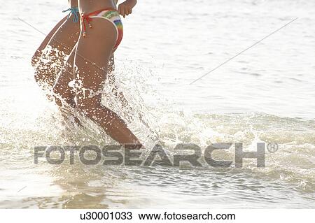 Young women running in water, Guam, USA View Large Photo Image Stock Image - Young women running in water, Guam, USA. Fotosearch