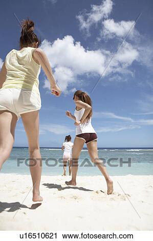 Young women running on beach, Guam, USA View Large Photo Image Stock Image - Young women running on beach, Guam, USA. Fotosearch