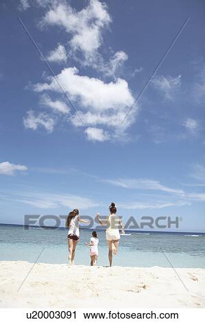 Young women running on beach, Guam, USA View Large Photo Image Stock Image - Young women running on beach, Guam, USA. Fotosearch