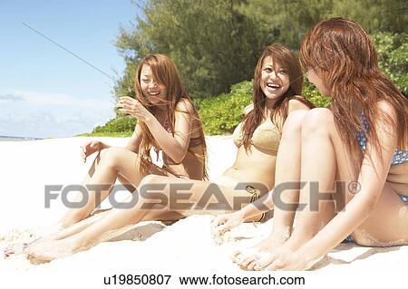 Young women sitting on beach and talking, Guam, USA View Large Photo Image Stock Photo - Young women sitting on beach and talking, Guam, USA. Fotosearch