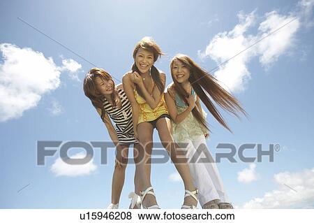 Young women standing and smiling, Guam, USA View Large Photo Image Stock Photo - Young women standing and smiling, Guam, USA. Fotosearch