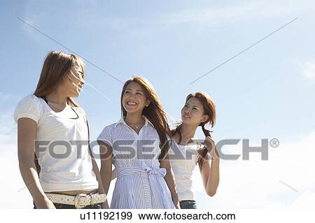 Stock Photo - Young women standing, Guam, USA. Fotosearch
