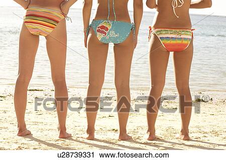 Young women standing in bikini, rear view, low section, Guam, USA View Large Photo Image Stock Image - Young women standing in bikini, rear view, low section, Guam, USA. Fotosearch