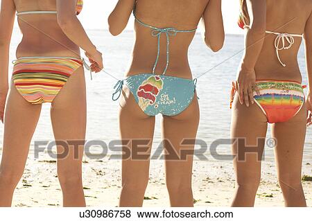 Young women standing in bikini, rear view, midsection, Guam, USA View Large Photo Image Stock Photo - Young women standing in bikini, rear view, midsection, Guam, USA. Fotosearch