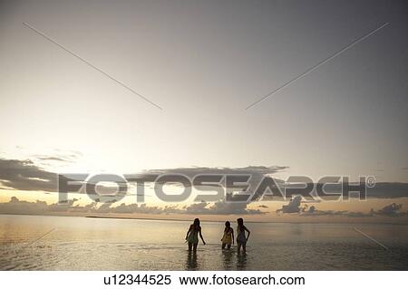 Young women standing in sea, Guam, USA View Large Photo Image Stock Photography - Young women standing in sea, Guam, USA. Fotosearch