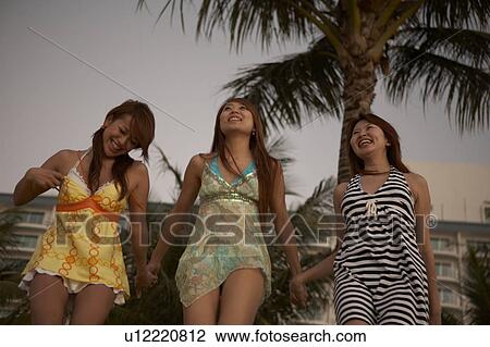Young women standing on beach, Guam, USA View Large Photo Image Stock Image - Young women standing on beach, Guam, USA. Fotosearch