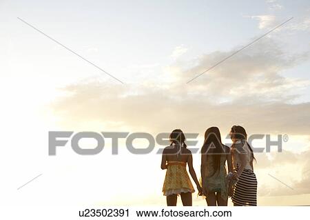 Young women standing side by side, Guam, USA View Large Photo Image Stock Image - Young women standing side by side, Guam, USA. Fotosearch