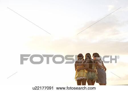 Young women standing with arm around, Guam, USA View Large Photo Image Stock Image - Young women standing with arm around, Guam, USA. Fotosearch