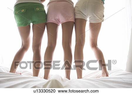 Stock Image - Young women's back shot. Fotosearch