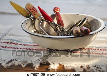 Stock Photo - Antique cooking utensils in bowl. Fotosearch