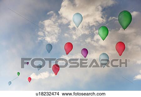 Balloons flying against sky View Large Photo Image Picture - Balloons flying against sky. Fotosearch