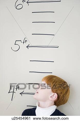 Boy (8-9) measuring height against chart View Large Photo Image Stock Image - Boy (8-9) measuring height against chart. Fotosearch