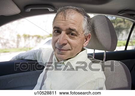Stock Image - Brooklyn, USA, New York State, New York City, senior man sitting in car. Fotosearch