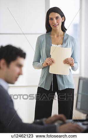 Stock Image - Business man and woman in office. Fotosearch