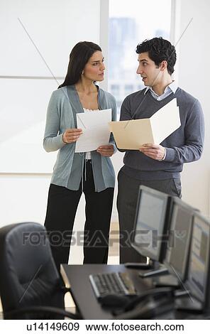 Business man and woman in office View Large Photo Image Stock Photo - Business man and woman in office. Fotosearch