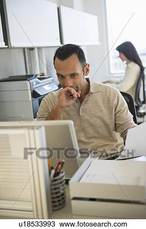 Stock Image - Business man and woman working in office. Fotosearch