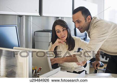 Business man and woman working in office View Large Photo Image Stock Photograph - Business man and woman working in office. Fotosearch