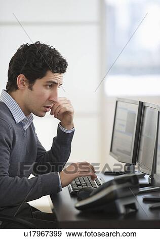 Business man using computer in office View Large Photo Image Stock Photo - Business man using computer in office. Fotosearch