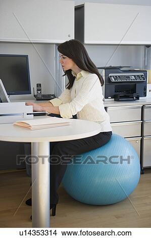 Business woman sitting on fitness ball View Large Photo Image Picture - Business woman sitting on fitness ball. Fotosearch